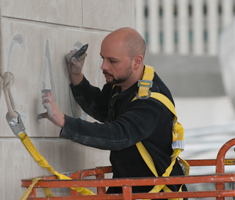 Olivier Dumont carefully carving titling into the Art Institute of Chicago's Modern Wing